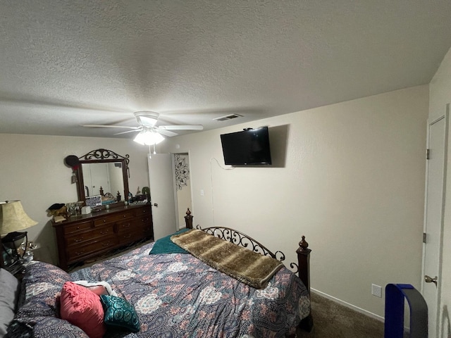 bedroom with carpet flooring, ceiling fan, and a textured ceiling