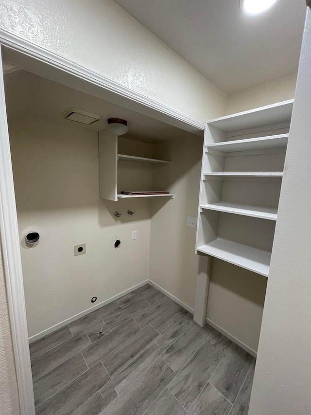 washroom featuring hookup for a washing machine, hookup for a gas dryer, hardwood / wood-style floors, and hookup for an electric dryer