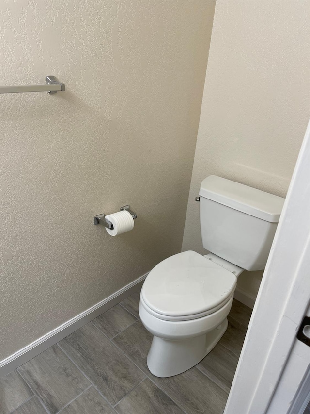 bathroom featuring hardwood / wood-style floors and toilet