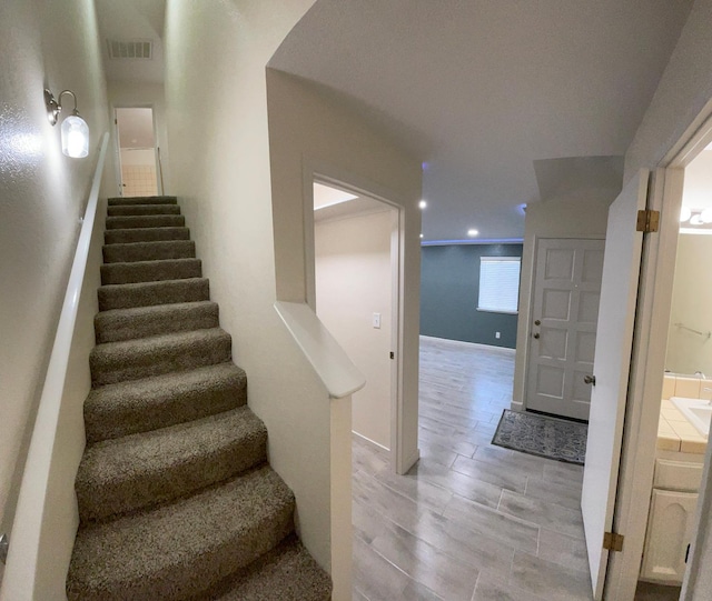 stairway featuring hardwood / wood-style floors