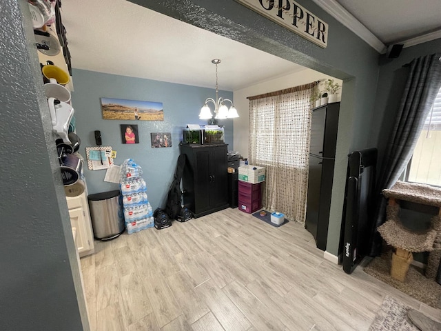 interior space with crown molding, a notable chandelier, and hardwood / wood-style flooring