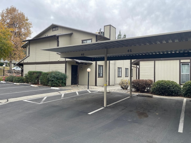 view of vehicle parking with a carport