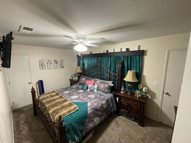 bedroom featuring a textured ceiling, carpet floors, and ceiling fan