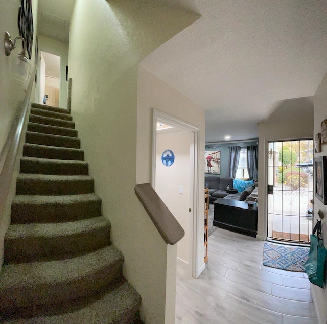 stairs featuring hardwood / wood-style floors