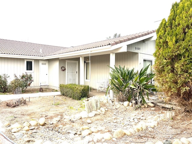 single story home featuring a tiled roof