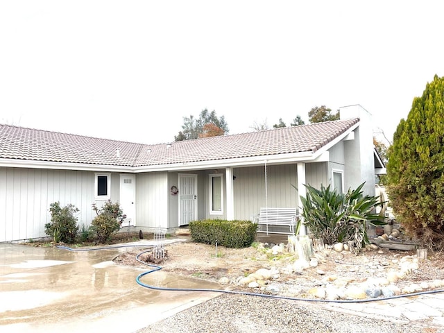 ranch-style house with a tile roof