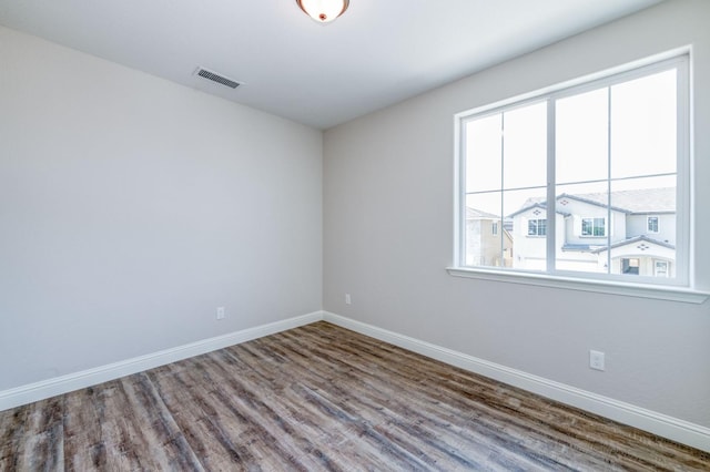 unfurnished room with wood-type flooring