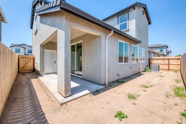 back of house with central AC and a patio