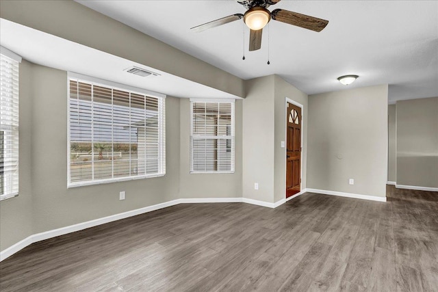 spare room featuring hardwood / wood-style floors and ceiling fan