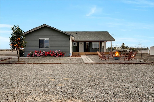 single story home with a fire pit and a patio area