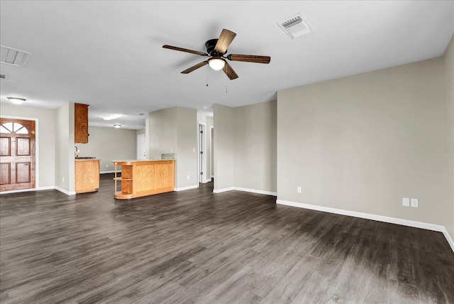 unfurnished living room with ceiling fan and dark hardwood / wood-style flooring