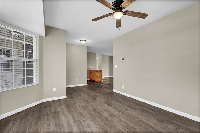 spare room with ceiling fan and dark hardwood / wood-style flooring