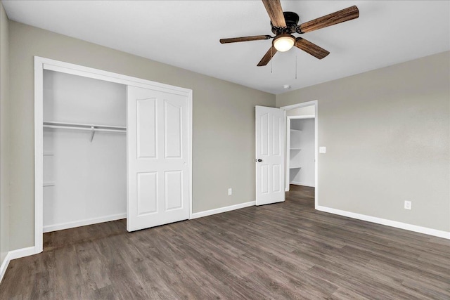 unfurnished bedroom featuring ceiling fan, dark wood-type flooring, and a closet