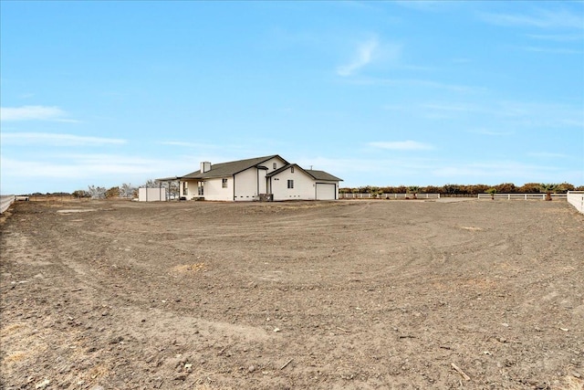 view of yard with a rural view