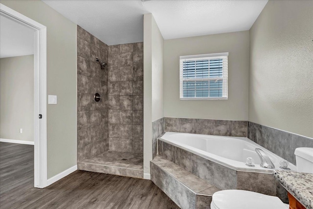 bathroom with plus walk in shower, hardwood / wood-style floors, and toilet