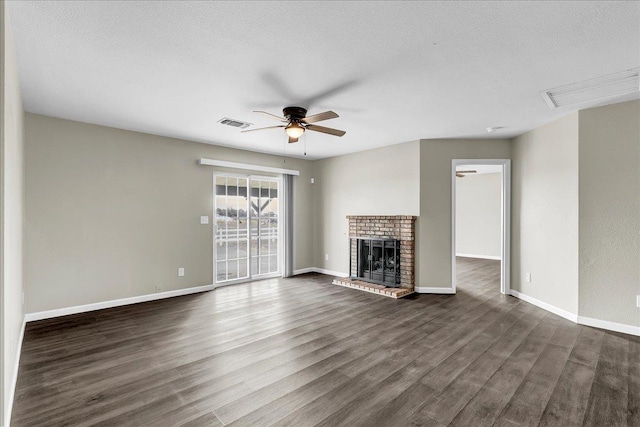 unfurnished living room featuring a fireplace, ceiling fan, and dark wood-type flooring