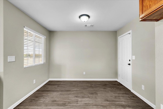 spare room featuring dark hardwood / wood-style flooring