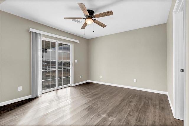 spare room featuring wood-type flooring and ceiling fan