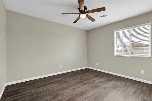 empty room with dark hardwood / wood-style flooring and ceiling fan