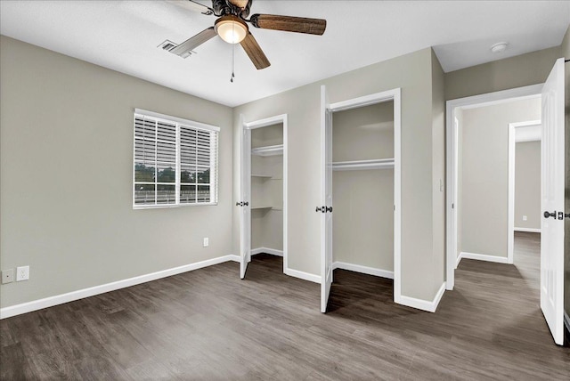 unfurnished bedroom with ceiling fan and dark hardwood / wood-style floors