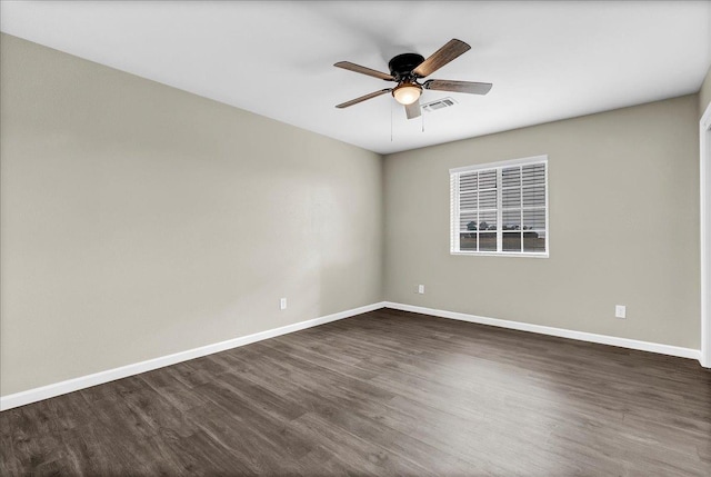 empty room with dark hardwood / wood-style floors and ceiling fan