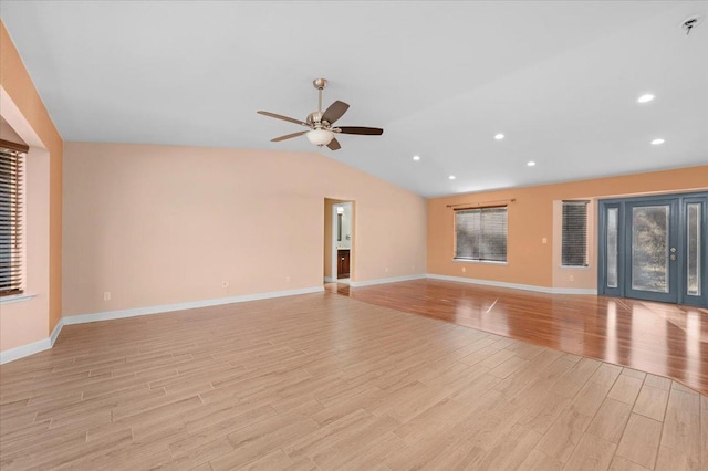 unfurnished living room with ceiling fan, vaulted ceiling, and light hardwood / wood-style flooring