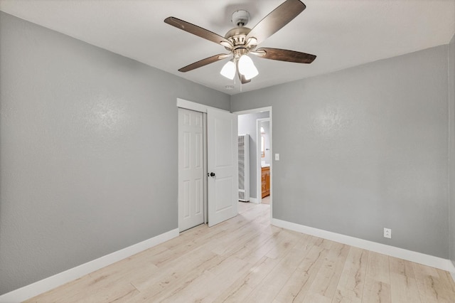 unfurnished room with ceiling fan and light wood-type flooring