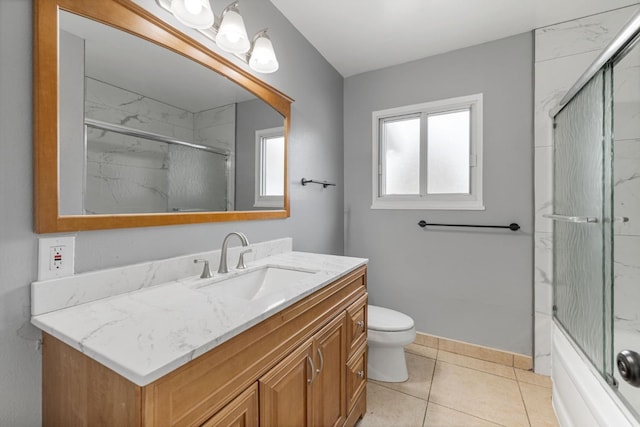 full bathroom featuring vanity, toilet, tile patterned flooring, and combined bath / shower with glass door