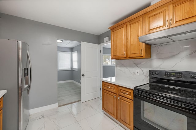 kitchen featuring stainless steel fridge with ice dispenser, black electric range oven, and tasteful backsplash