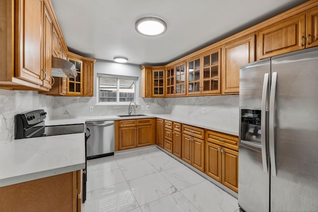 kitchen with wall chimney exhaust hood, stainless steel appliances, sink, and tasteful backsplash