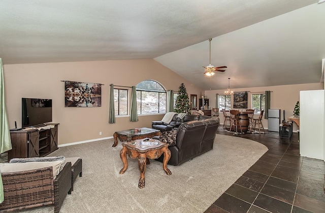 living room featuring vaulted ceiling, a textured ceiling, baseboards, and ceiling fan with notable chandelier