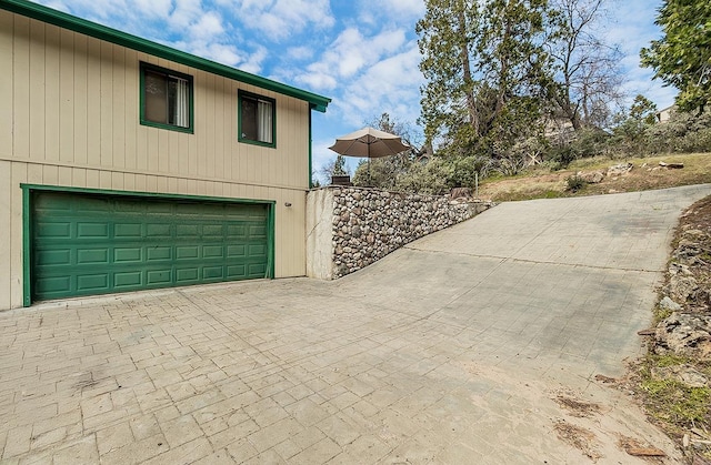 exterior space featuring decorative driveway