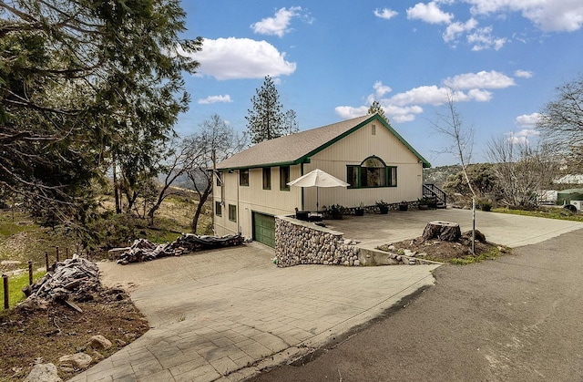 view of front facade featuring an attached garage and decorative driveway