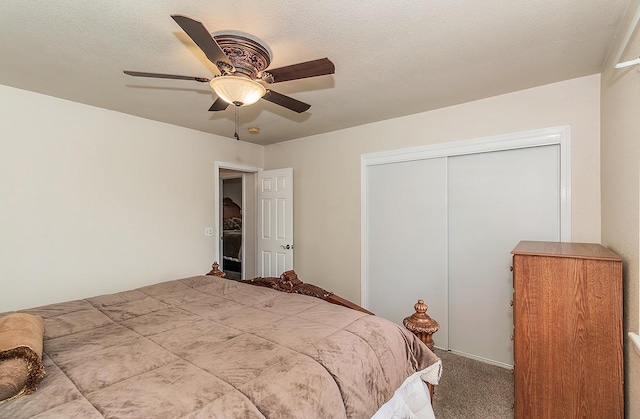 bedroom with a closet, light colored carpet, ceiling fan, and a textured ceiling