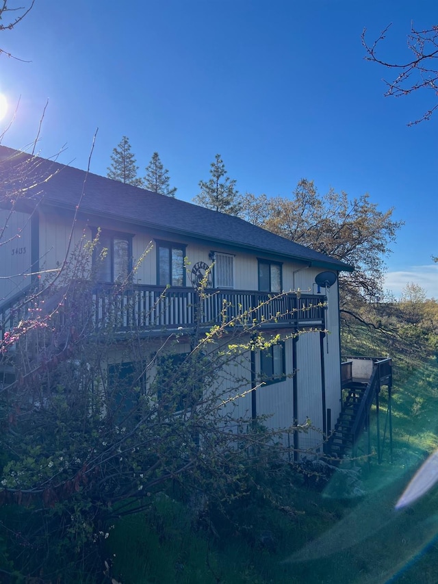 view of front of property with stairs and a deck