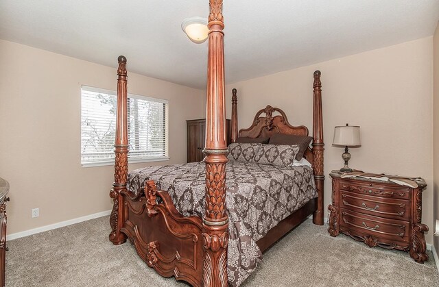 bedroom with light carpet and baseboards