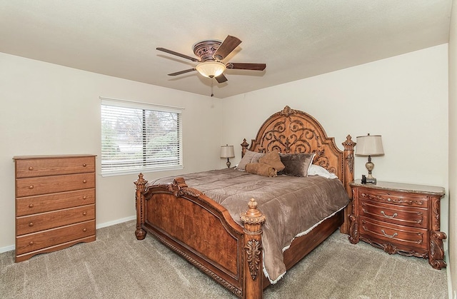 bedroom with baseboards, a textured ceiling, a ceiling fan, and light colored carpet