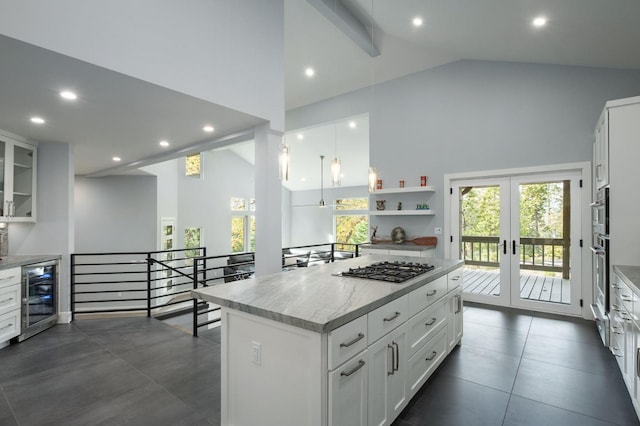 kitchen featuring white cabinets, high vaulted ceiling, wine cooler, and a kitchen island