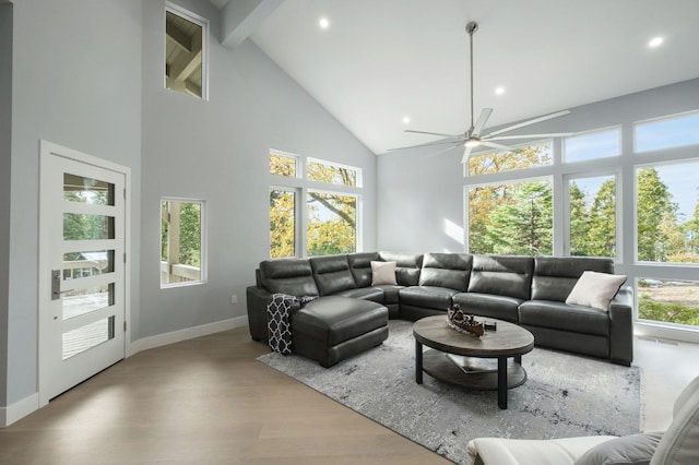 sunroom / solarium featuring vaulted ceiling with beams, a wealth of natural light, and ceiling fan