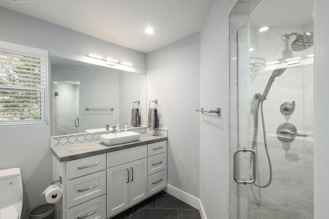 bathroom with toilet, vanity, tile patterned floors, and walk in shower