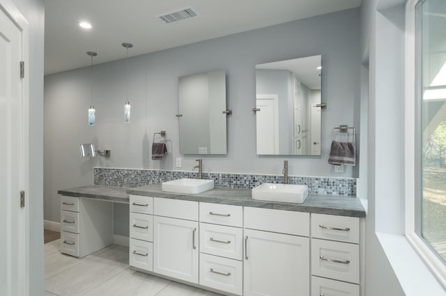 bathroom featuring vanity and tasteful backsplash