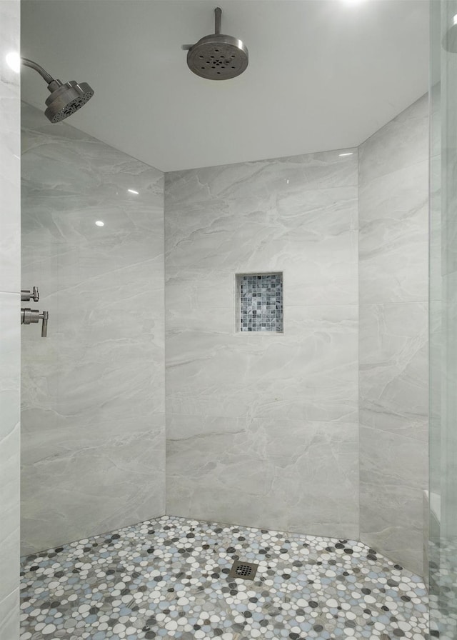 bathroom with a tile shower