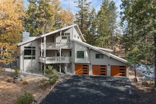 view of front of house with a garage and a balcony