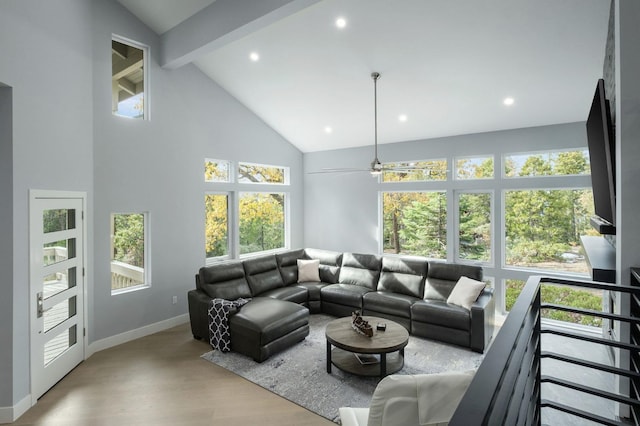 living room with beam ceiling, light wood-type flooring, high vaulted ceiling, and ceiling fan