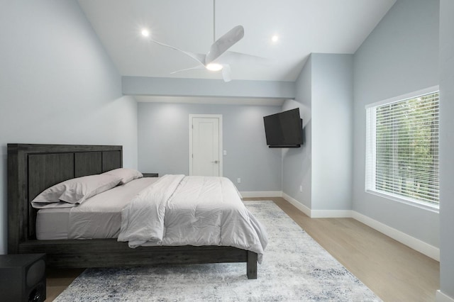 bedroom with vaulted ceiling, light hardwood / wood-style flooring, and ceiling fan