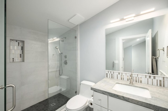 bathroom featuring lofted ceiling, vanity, an enclosed shower, and toilet