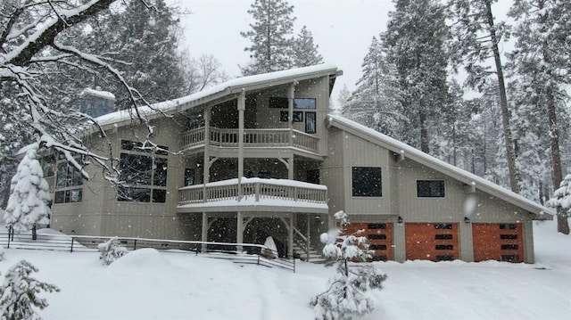 snow covered property featuring a balcony