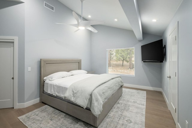 bedroom with ceiling fan, lofted ceiling with beams, and light hardwood / wood-style floors