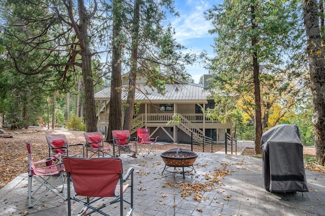 view of patio / terrace featuring grilling area, a fire pit, and a deck