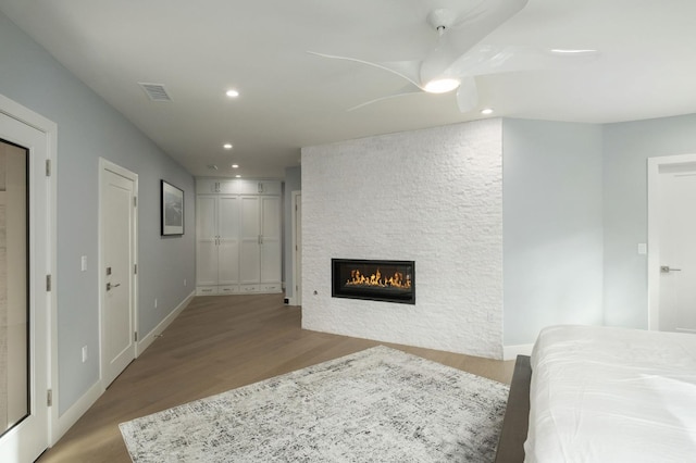 living room with a fireplace and wood-type flooring